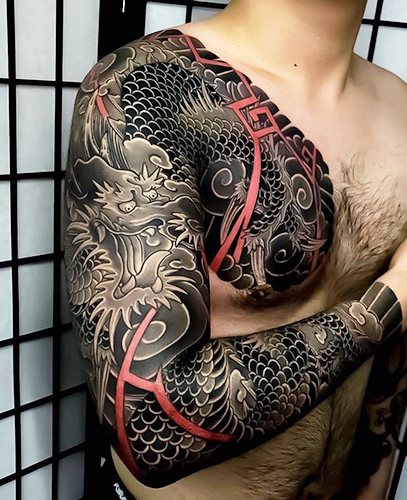 Tattoo in Japanese style. Sketches on the arm, sleeve, leg, back: dragon, carp, tiger, snake, fish, samurai, flowers, fox, mask, phoenix. Photo
