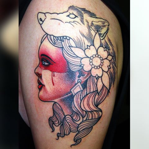 Tattoo wolf on a girl's shoulder