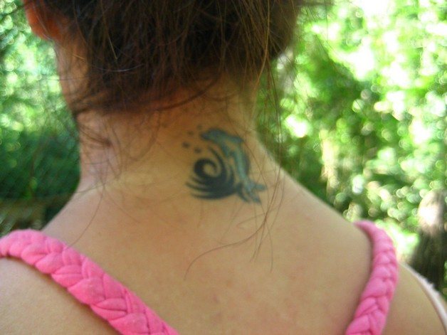 Tattoo animal on the back of the neck.