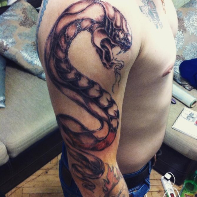 Snake tattoo with an open mouth