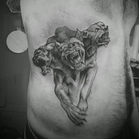 Cerberus tattoo on side of man