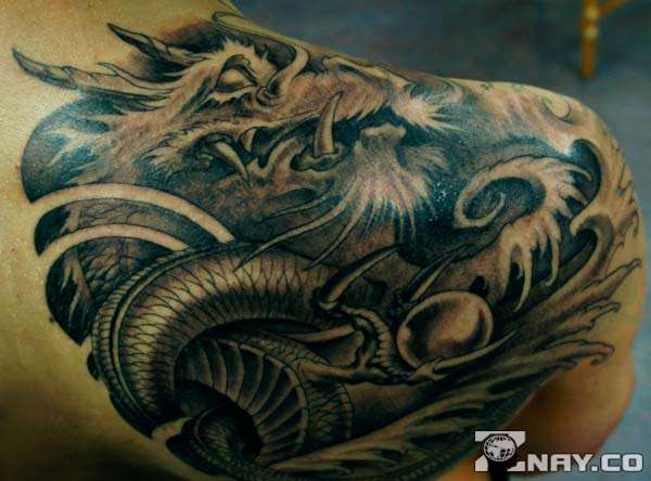 Tattoo of a dragon on a guy's back