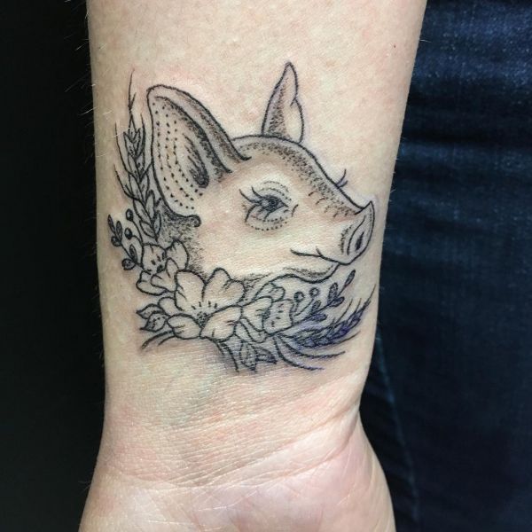 Pig head tattoo as an outline on the wrist