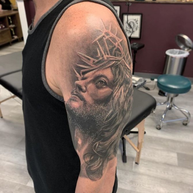 jesus christ tattoo on his arm