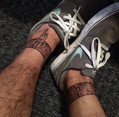Shackles tattoo on legs