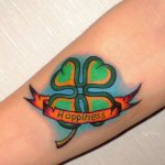 Tattoo of a clover with writing