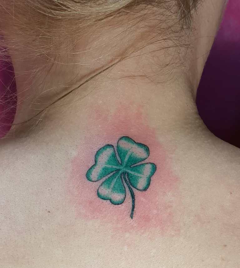 Tattoo of a clover on a girl