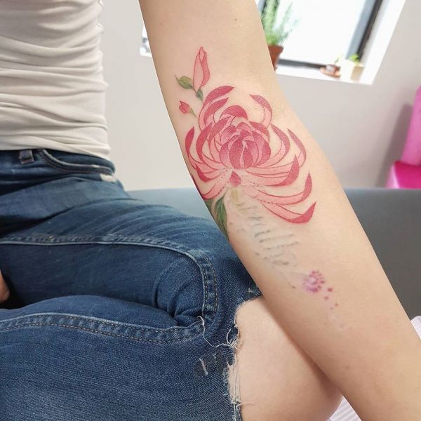 Tattoo of red chrysanthemum on a girl's arm