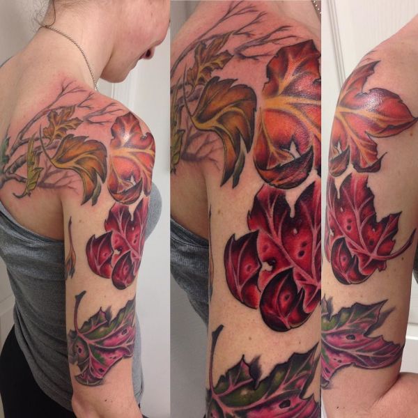 Tattoo of red and orange leaves on a girl's shoulder