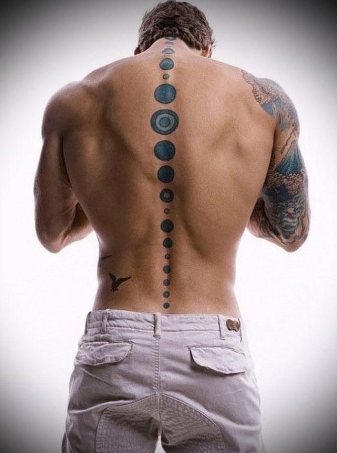 Tattoo circles on the male spine
