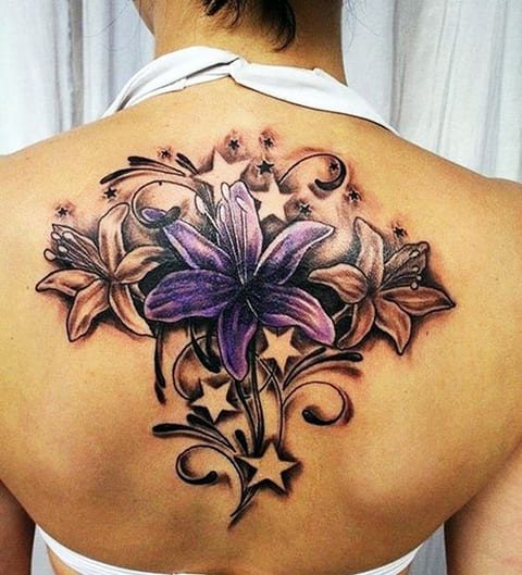 Tattoo of a lily on the back of a girl - photo