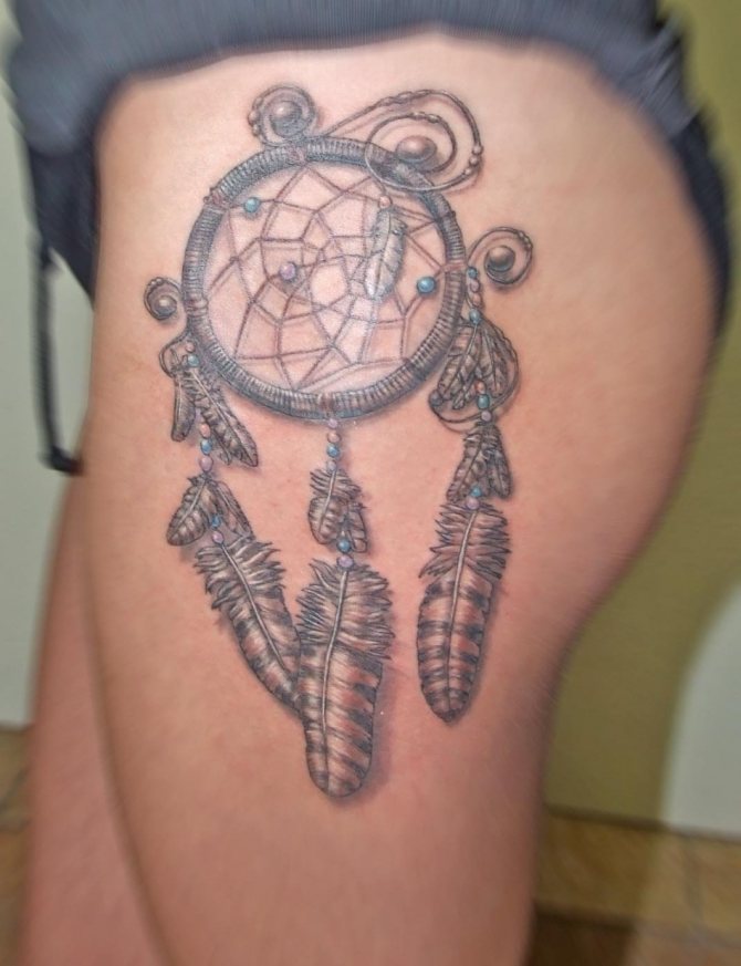 Tattoo of a dreamcatcher on the hip