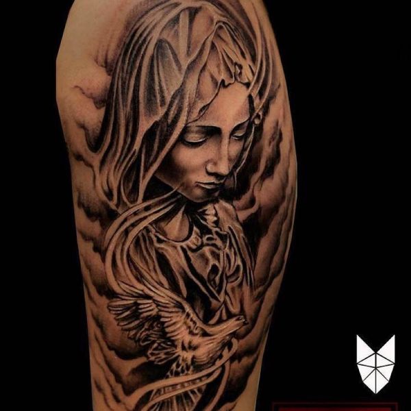 Tattoo of Mother of God with a bird