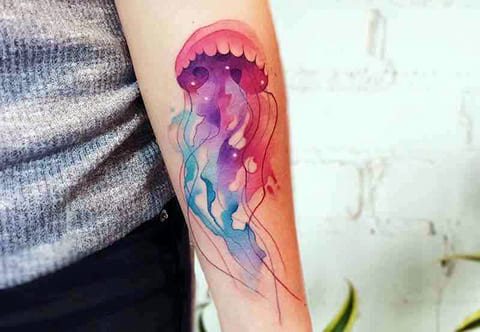 Watercolor jellyfish tattoo on arm