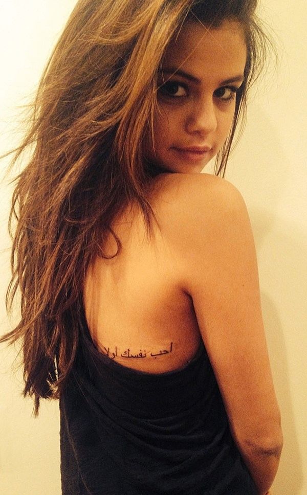 Tattoo on the shoulder blade, an inscription on Selena Gomez