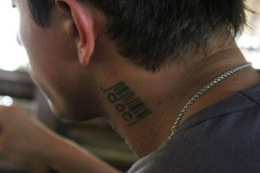 Tattoo on the neck of a man in the form of a bar code