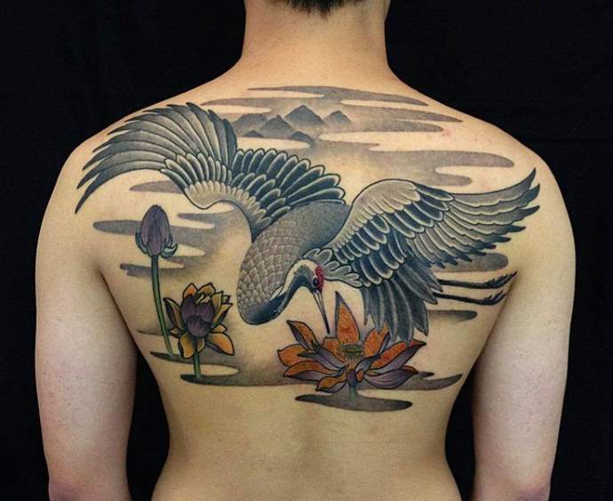 Tattoo on the back of a woman - a crane