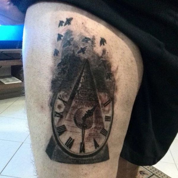 Pyramid tattoo with a clock on a guy's leg