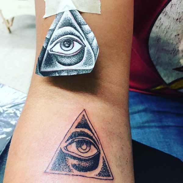Pyramid and eye mountain tattoo on wrist