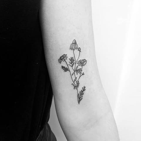 Daisy tattoo on forearm