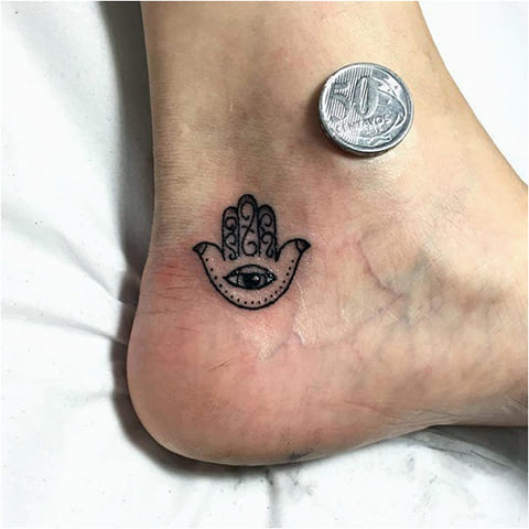 Tattoo of Fatima hand on ankle