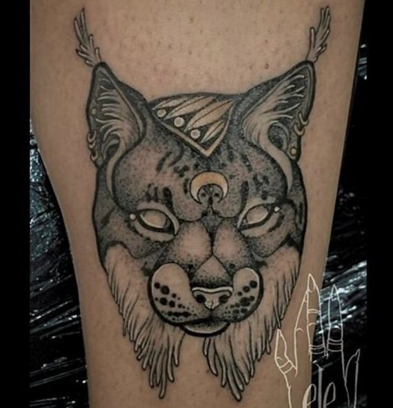 Tattoo of a lynx on his leg