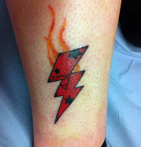 Tattoo with colored lightning on his leg