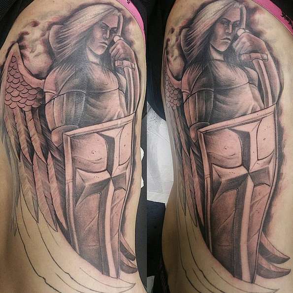 Tattoo of the Archangel with a shield and a sword in his hands
