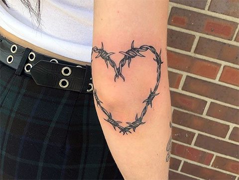 Barbed wire heart tattoo of a girl