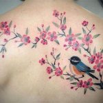 Tattoo with a cherry tree and bird