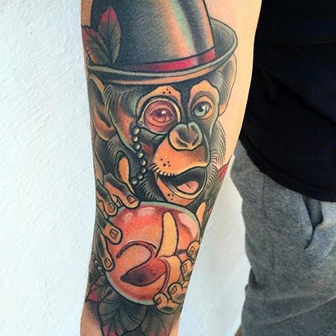 Tattoo of a chimp in a hat
