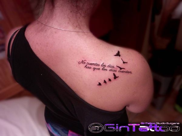 Tattoo of a flock of birds on a girl's shoulder
