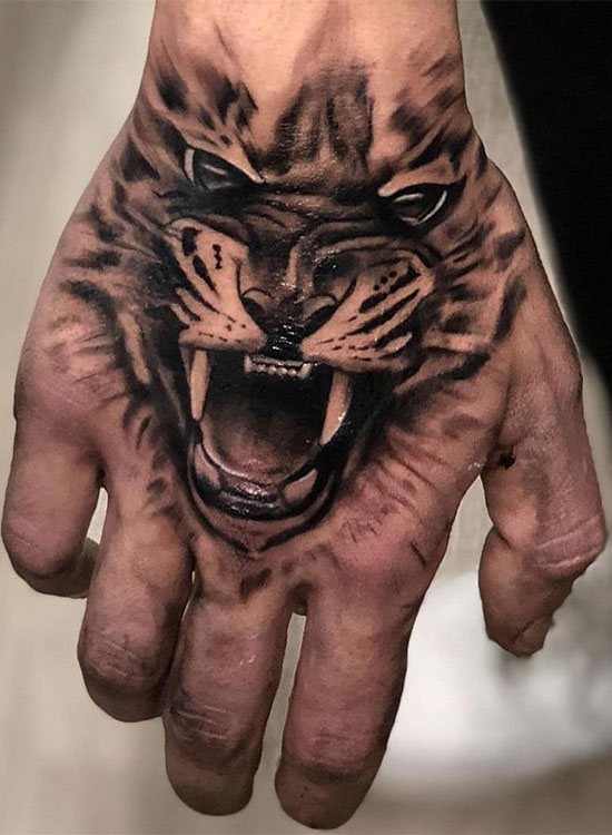 Tattoo of a tiger on his fist