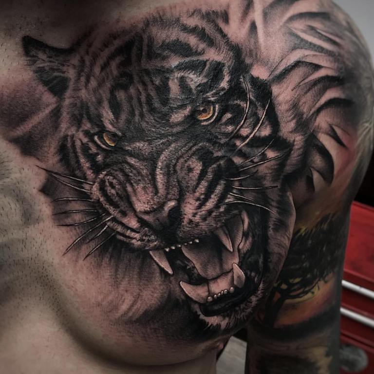 Tattoo of a tiger on his chest