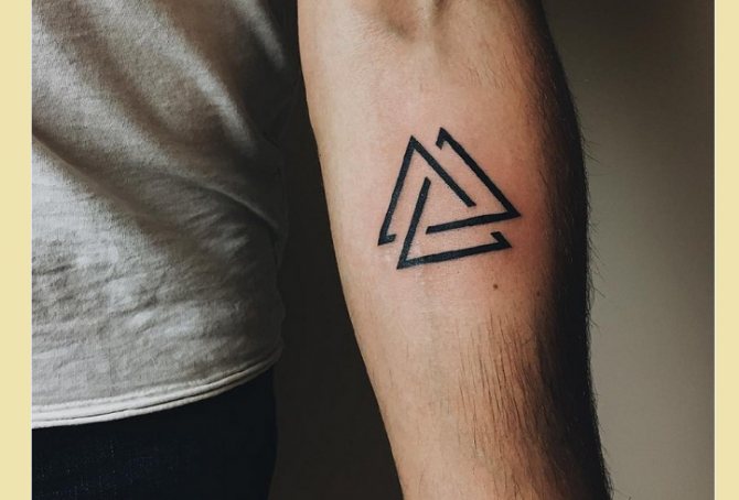 Triangle tattoo on his arm