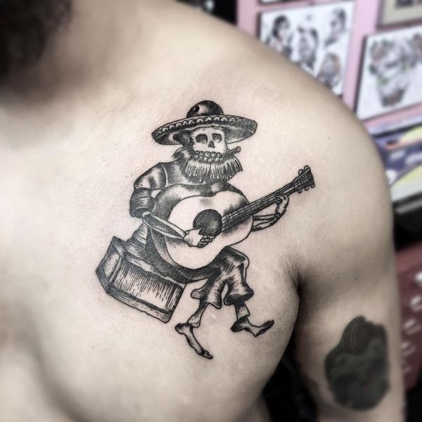 Mexican style tattoo on guy's chest