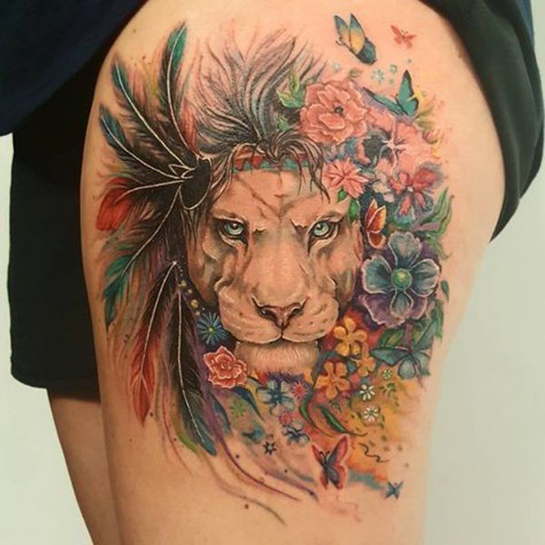 Tattoo in the form of a painting of a lion with multicolored feathers