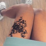 Tattoo in the form of lace with vetus on a girl's leg