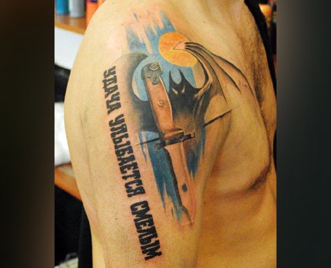 Military Intelligence bat tattoo on shoulder