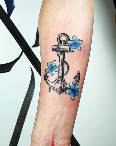 Anchor tattoo with flowers on the wrist of a girl - photo