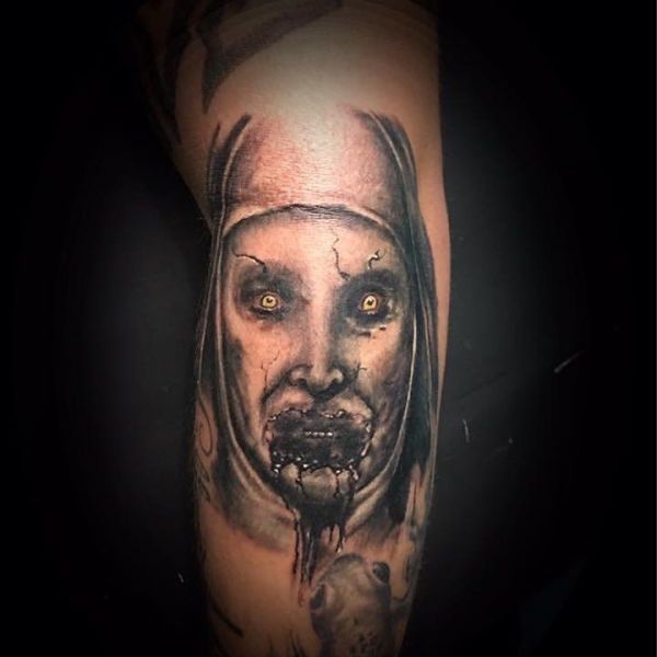 Tattoo of evil on his leg as an image of grandmother's face