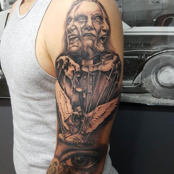 Tattoo of evil on a guy's shoulder