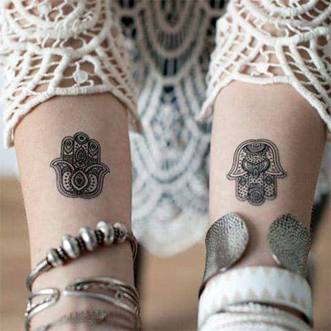 Tattoos of Fatima hand on wrist