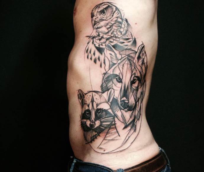 wolf, raccoon and owl on the tattoo