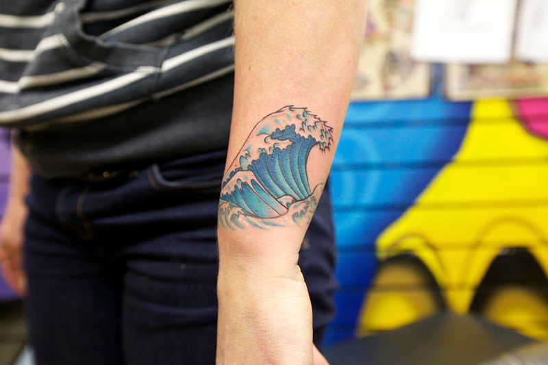 Wave tattoo on forearm